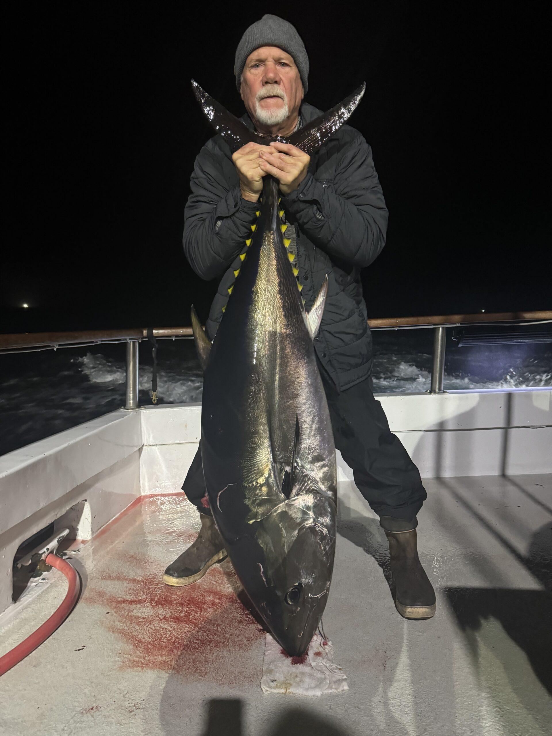 Angler with 100-pound bluefin tuna.