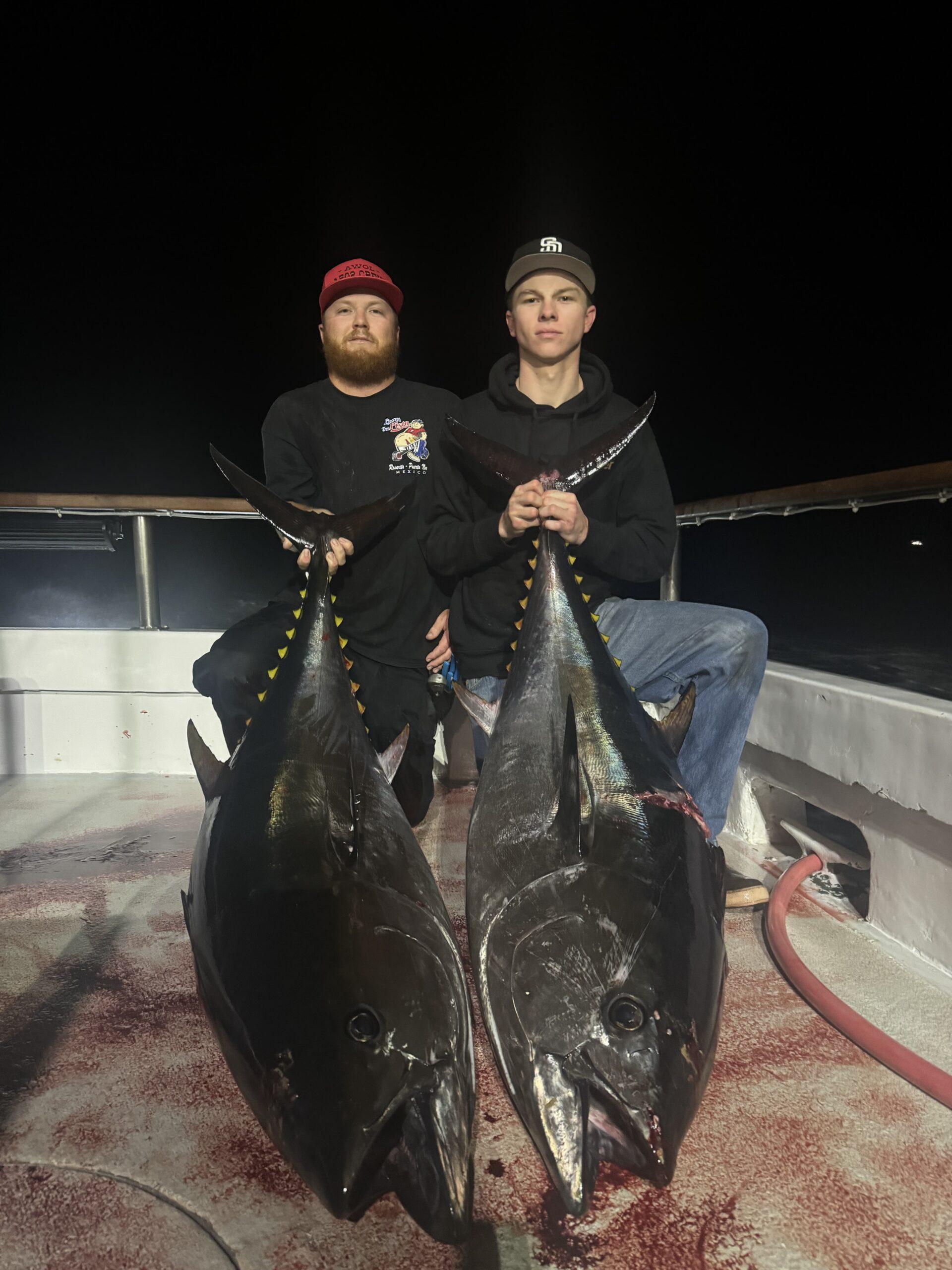 Two anglers with two large bluefin tuna.
